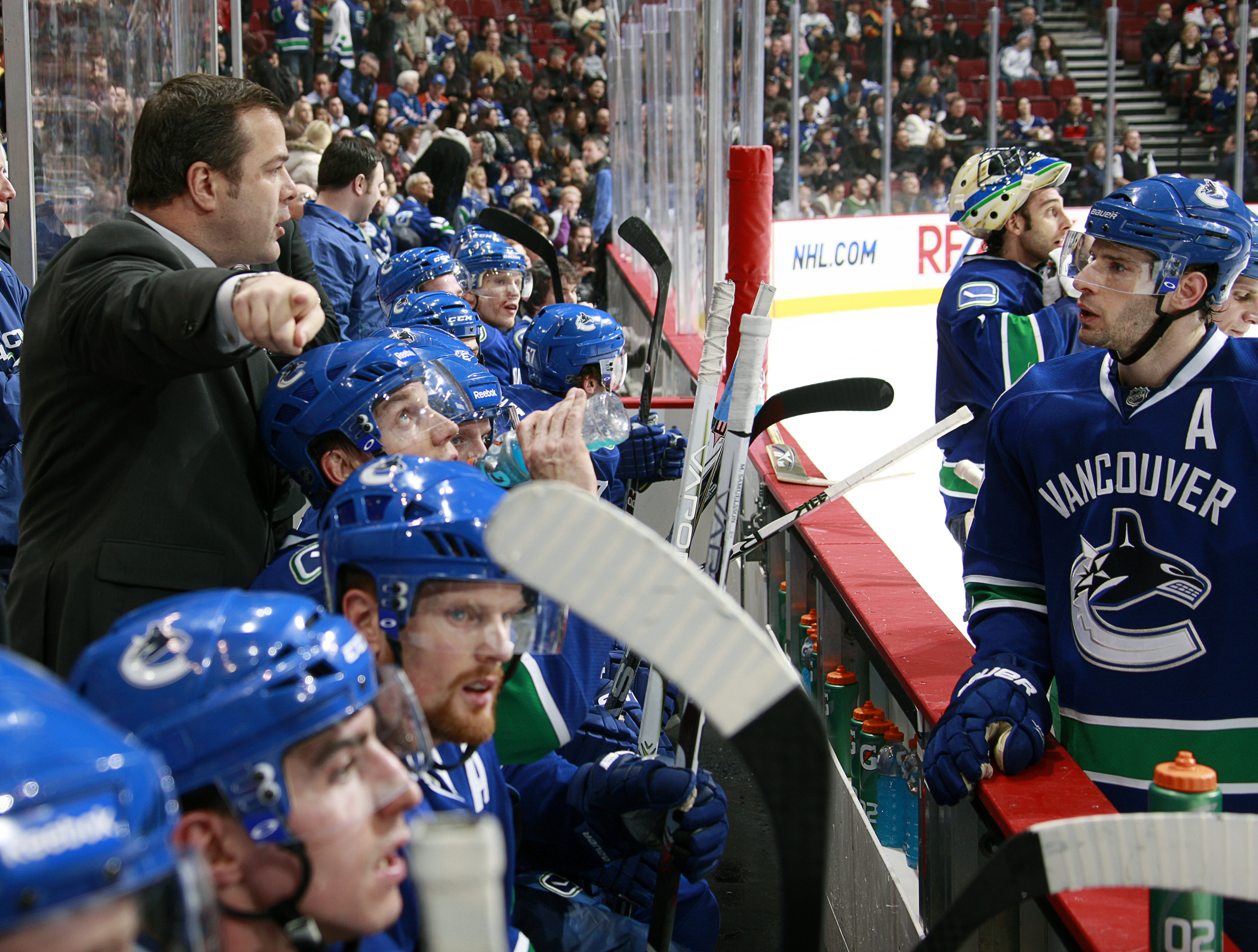 VANCOUVER, CANADA - JANUARY 26: Head coach Alain Vigneault of the Vancouver Canucks talks to Ryan Kesler #17 during their game against the Nashville Predators at Rogers Arena on January 26, 2011 in Vancouver, British Columbia, Canada. Vancouver won 2-1. (Photo by Jeff Vinnick/NHLI via Getty Images)
