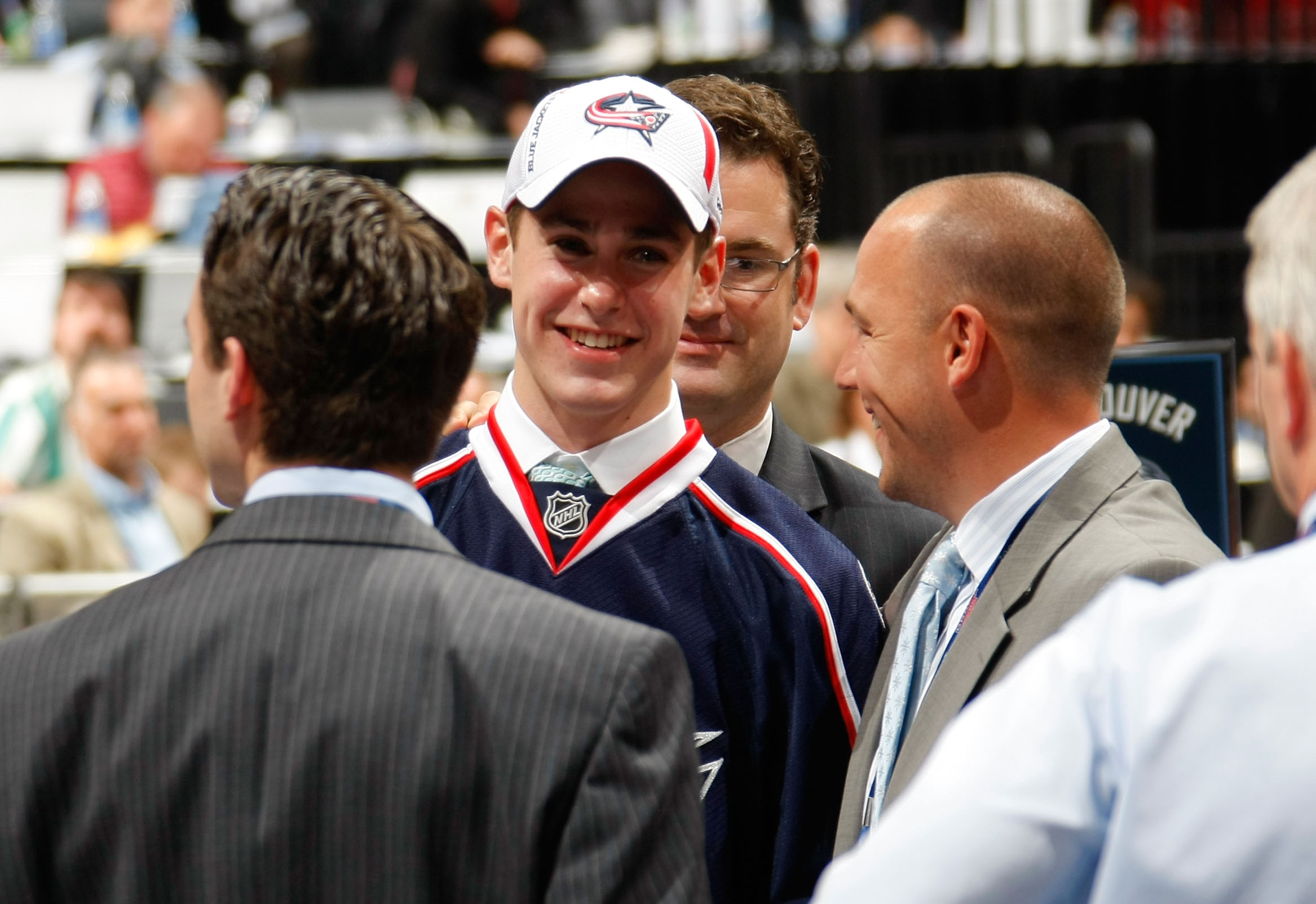 MONTREAL , QC - JUNE 26:  John Moore smiles while standing near the Columbus Blue Jackets draft table after being drafted by the Blue Jackets during the first round of the 2009 NHL Entry Draft at the Bell Centre on June 26, 2009 in Montreal, Quebec, Canada.  (Photo by Dave Sandford/NHLI via Getty Images)